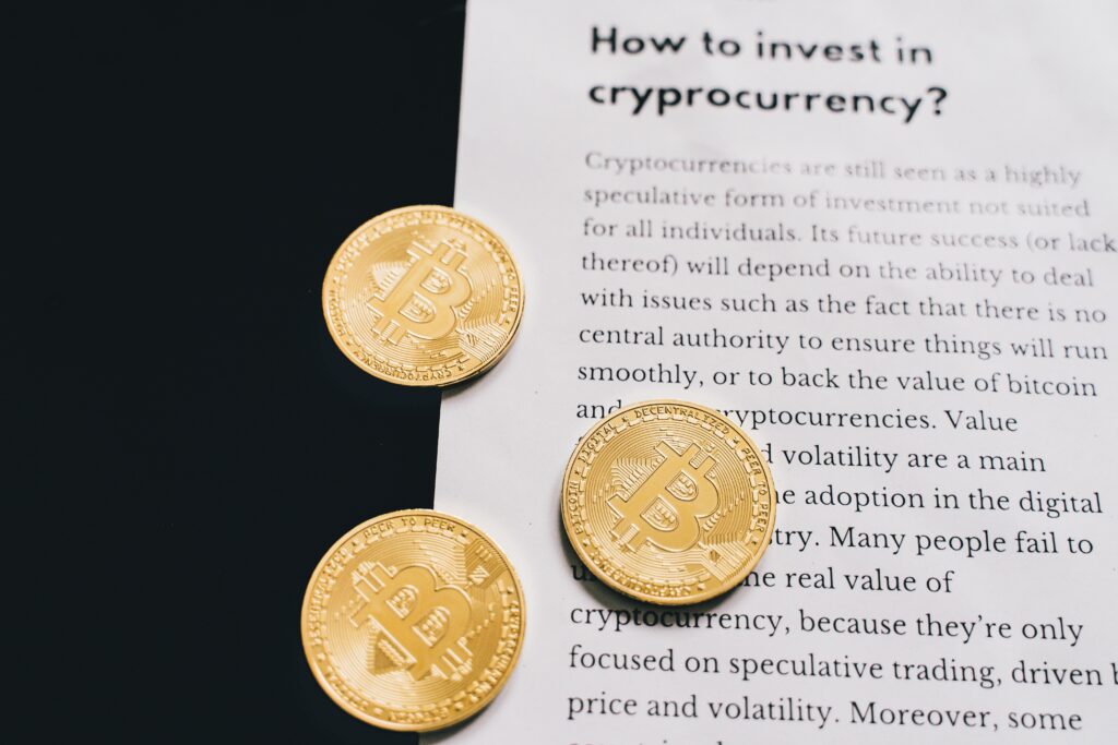 Gold Bitcoin coins on top of a cryptocurrency investment guide. High-quality finance and cryptocurrency image.