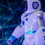 Close-up of a modern humanoid robot with glowing blue lights and futuristic design.